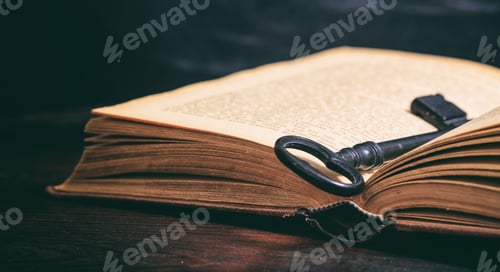 Preview: Key on a vintage book on wooden background