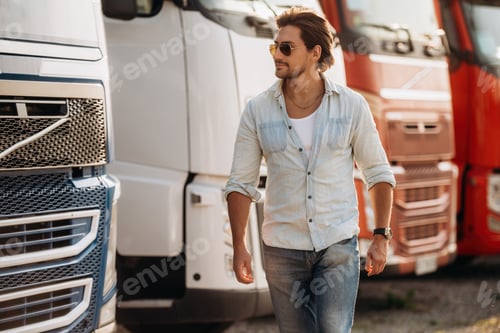 Preview: Cool look, in sunglasses. Truck driver is near the transport outdoors