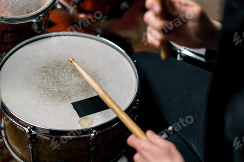 Preview: male drummer plays a drum kit in a recording studio at professional musician's rehearsal recording