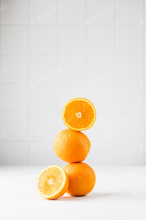 Preview: Still life balance of oranges on a white background. Copy space.