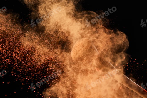 Preview: cosmetic brush with colorful orange powder explosion on black background