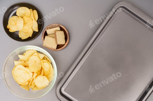 Preview: Flat lay of snack, Crispy potato chip and wafer in various containers with plastic tray