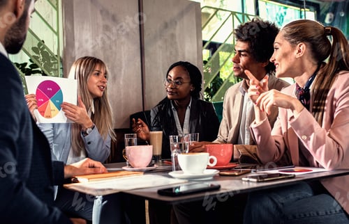 Preview: Group of business people having meeting in cafe.