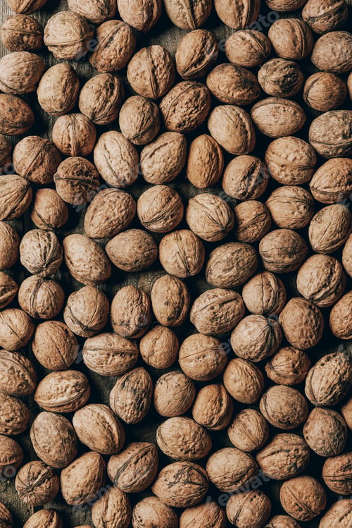 Preview: top view of healthy organic walnuts on wooden table, full frame background
