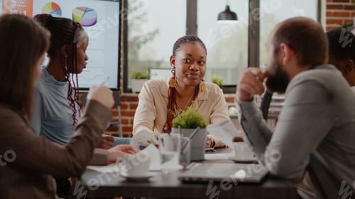 Preview: Close up of company worker planning business strategy with colleagues