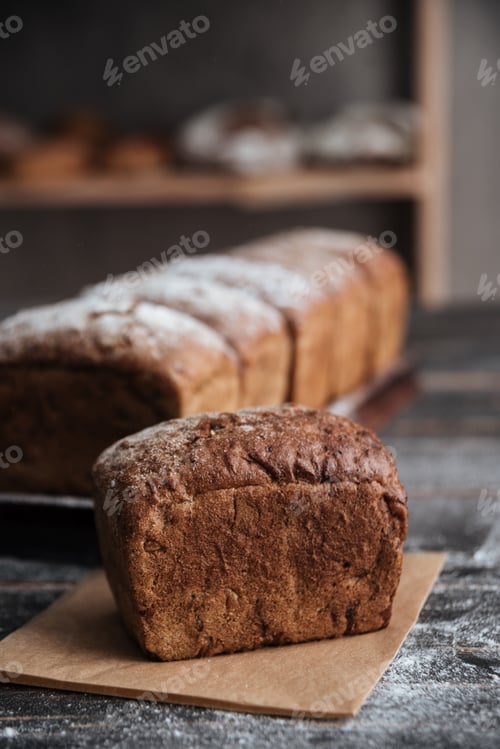 Preview: Bread with flour on dark wooden table
