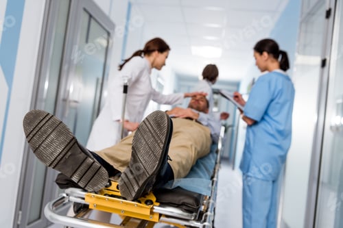 Preview: Doctors and nurse transporting patient on gurney