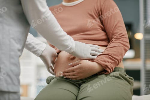 Preview: Doctor Examining Belly of Pregnant Woman