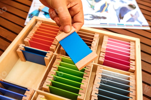 Preview: Girl holds a tablet from a montessori color box, gradient colors to match the visual sense.
