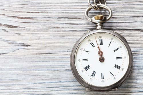 Preview: two minutes to twelve on retro watch on gray wood