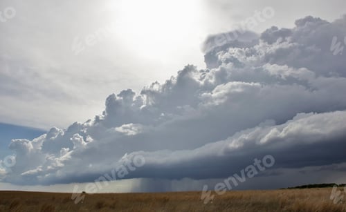 Preview: Dramatic clouds over a golden field.
