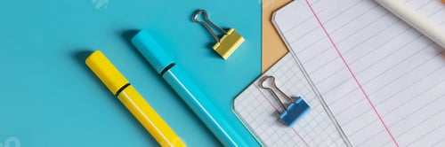 Preview: School stationery, color pencils, paints, notepad on blue table. Back to school background. Kids