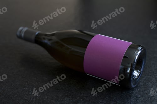 Preview: Landscape shot of a dark wine bottle isolated on a black shiny table
