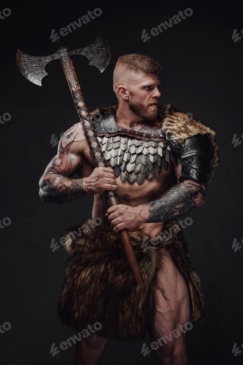 Preview: Brutal tattooed warrior wearing light armour and fur holding two-handed axe in dark studio