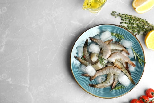 Preview: Flat lay composition with fresh raw shrimps on light grey marble table. Space for text