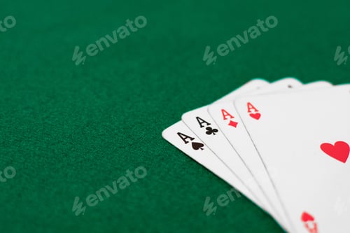 Preview: Four aces on a green table surface with copy space.