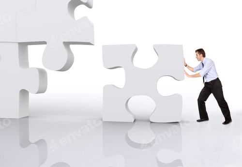 Preview: Business Man Building A 3D Puzzle Over White