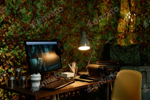 Preview: Desk with lamp standing next to computer monitor with broadcast from cameras