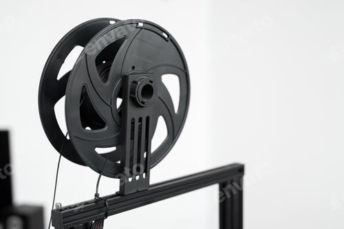 Preview: Black filament on a 3D printer in the lab.