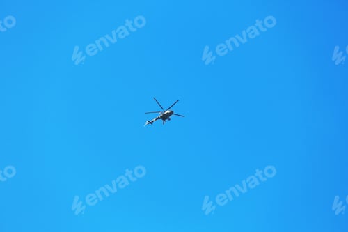 Preview: Modern military helicopter flying in blue sky