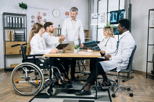 Preview: Five multiracial medical workers having conference meeting