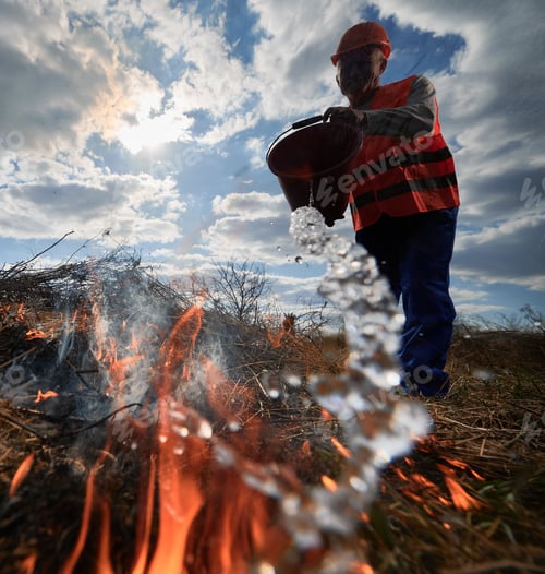 Preview: Fireman ecologist fighting fire in field