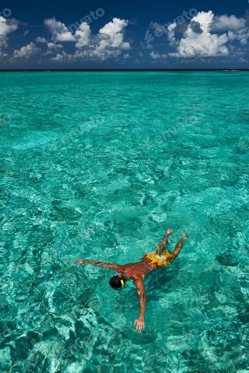 Preview: Man Snorkeling In Crystal Clear Turquoise Water At Tropical Beach