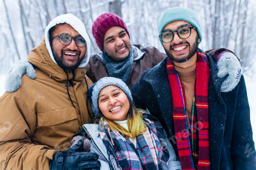 Preview: four people taking selfie shot outdoors at new year holidays