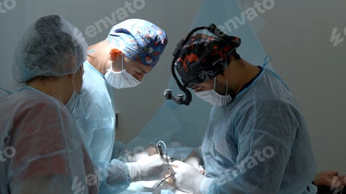 Preview: Group of surgeons working in operating room at hospital. Action. Nurse helping two doctors during