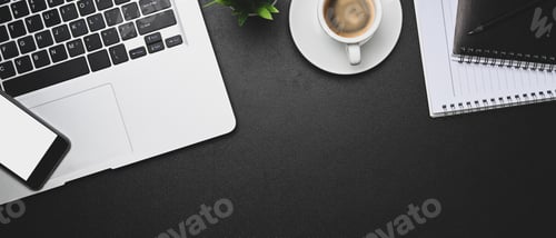 Preview: Workplace with computer laptop, smart phone, coffee cup and notebook on dark background.