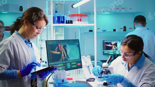 Preview: Nurses analysing together virus mutations working overtime