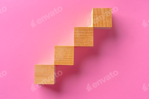 Preview: Top view of toy wooden blocks on pink