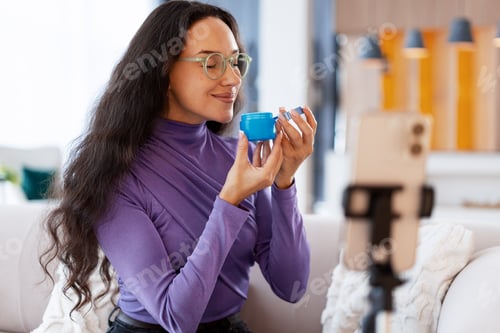 Preview: Woman influencer vlogging beauty product review at home