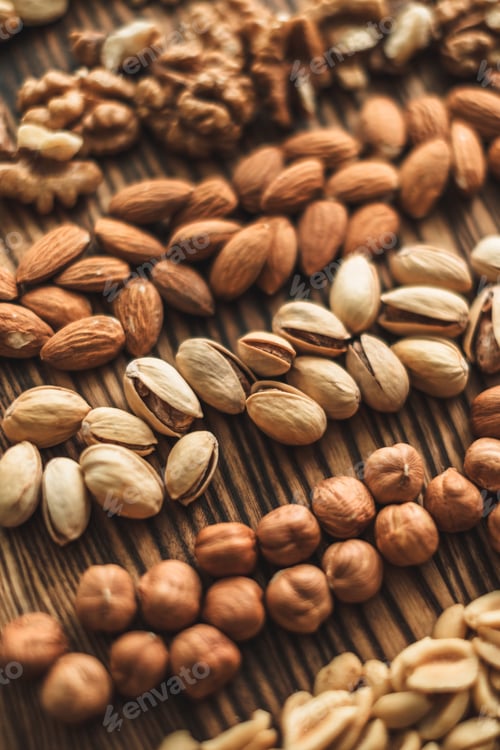 Preview: Different types of nuts, nut mix of almonds, hazelnuts, cashews, peanuts on a wooden board. Close up