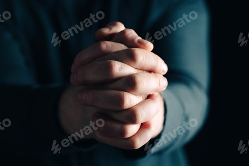 Preview: Man hands in praying position low key image