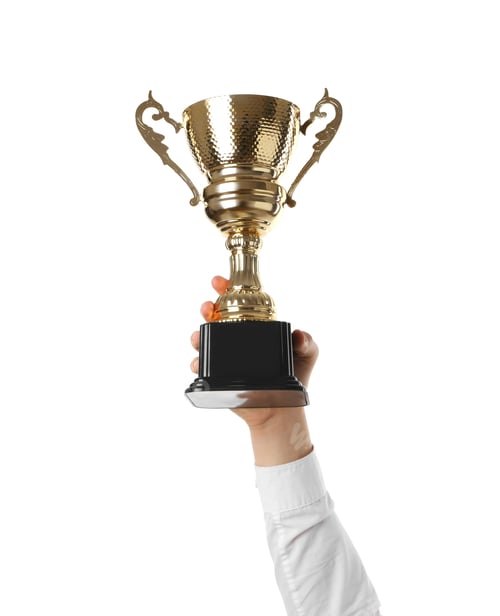 Preview: Man with golden trophy cup on white background, closeup