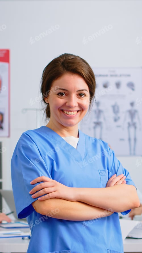 Preview: Portrait of young nurse standing in front of camera smiling