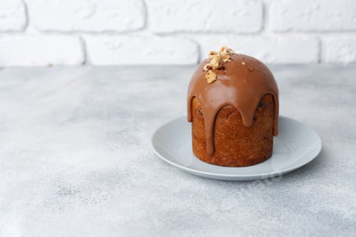 Preview: Ester cake with chocolate topping and nuts on gray background