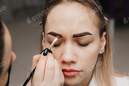 Preview: girl doing eyebrow microblading. applying eyebrow paint. facial skin care. lip augmentation