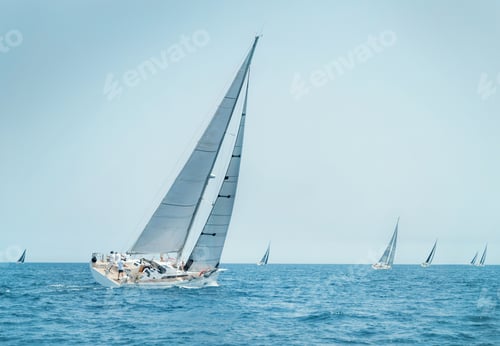 Preview: Sailboats races near Brindisi under blue sky. Crew members working together on deck