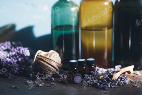 Preview: Bottle with aroma oil and lavender flowers on blue background