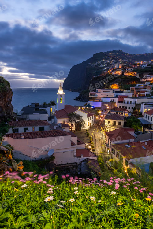 Preview: Cityscape of Camara de Lobos at dusk illuminated architecture of the seaside town in Madeira island