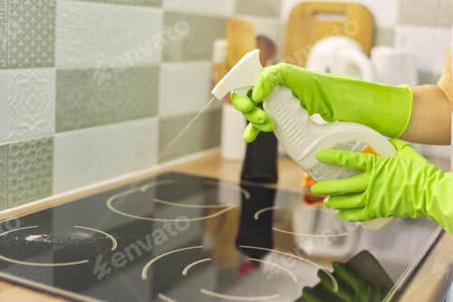 Preview: Closeup of hand woman cleaning modern cooking glass