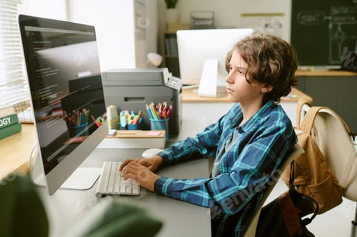 Preview: Teenage Caucasian Boy Using Desktop Computer While Studying in Classroom
