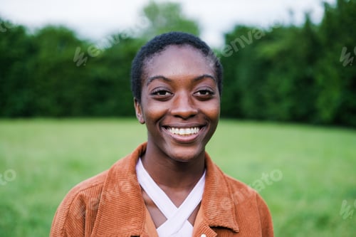 Preview: Close-up of woman with short hair smiling outdoors on a sunset in the park