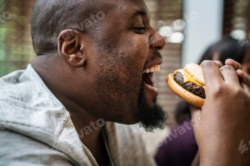 Preview: Man eating a big hamburger