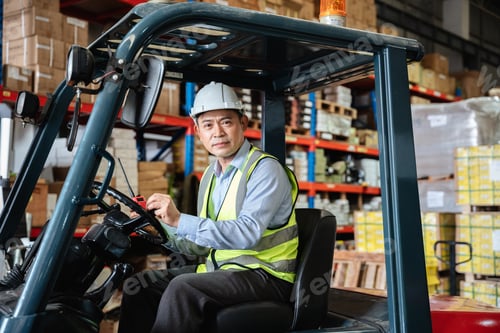 Preview: A warehouse worker forklift operator moves packages around with a manufacturing facility.