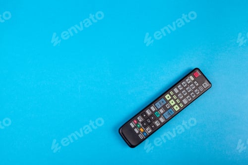 Preview: Remote control placed on a blue background ready for use at home