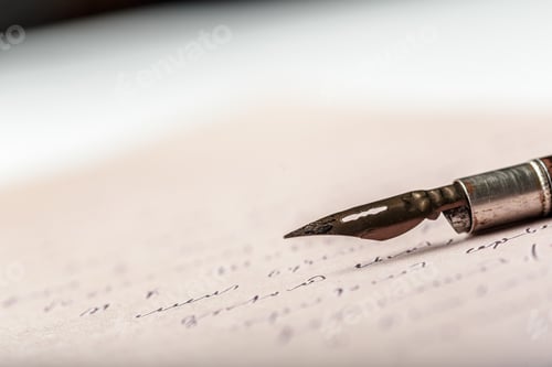 Preview: Close view of a fountain pen on handwritten notes on a desk in a bright room