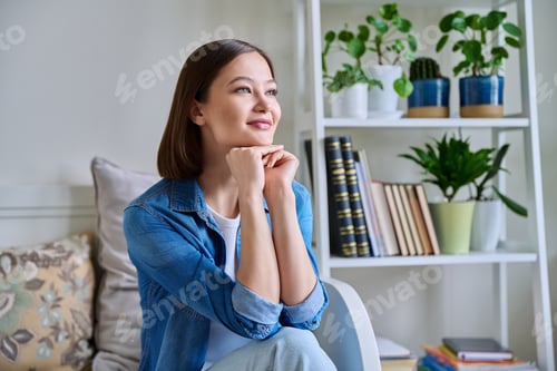 Preview: Portrait of young smiling woman in home interior